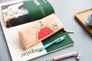Close up detail view of cute silicone pencil case featuring watermelon print and zipper.