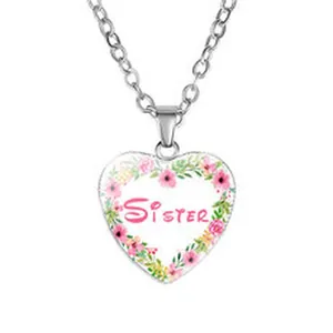 Vista detallada de un collar con colgante de corazón de plata y diseño de Sister.