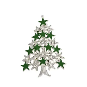 Detailed view of the sparkling rhinestone Christmas tree brooch, featuring green and silver stars.