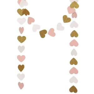 Detailed view of glitter gold pink white heart paper garland hanging party decoration.
