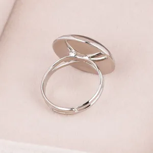 Detailed view of adjustable silver metal ring base with circular gem tray