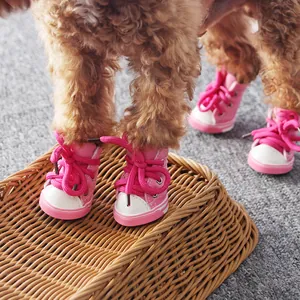Cute pink pet dog canvas shoes with lace-up design, breathable and non-slip for small dogs.