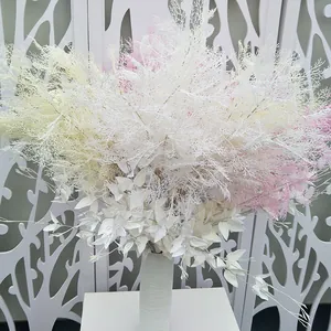 Detail view of artificial rime grass flower bouquet in vase for wedding home decoration.