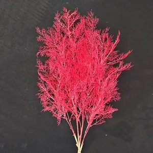 Artificial rime grass detail shot, vibrant red floral decor for wedding and home background use.