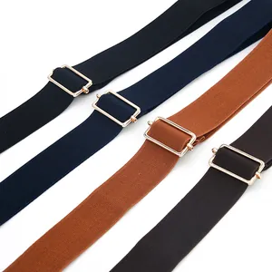 Close-up detail of elastic stretch belts with adjustable metal buckles in multiple colors.