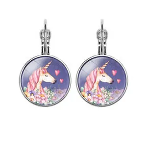 Close-up view of silver-tone lever-back earrings with a colorful pink unicorn design