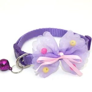 Detailed view of purple pet collar featuring layered mesh bow, pink ribbon and cute bell.