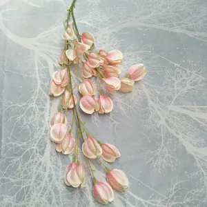Close-up of artificial pink lantern fruit vine hanging branch, delicate silk flower details for home decor.