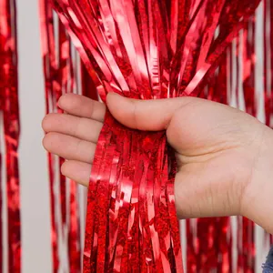 Red foil fringe curtain backdrop for parties, weddings, and celebrations. Shiny tinsel decor.