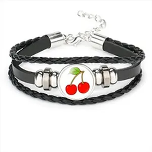 Multi-layer black braided leather bracelet featuring a vibrant red cherry glass cabochon