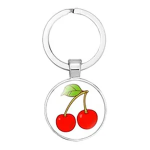 Detailed close-up of a silver 18mm round keychain pendant with a red cherry illustration