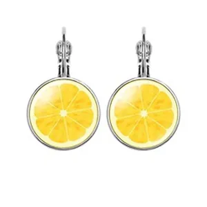 Macro detail of silver leverback earrings featuring yellow lemon slice glass cabochons