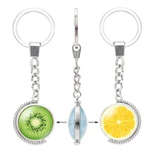 A rotating metal keychain featuring vibrant kiwi and lemon fruit pattern pendants