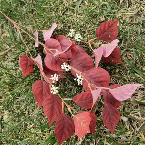 Artificial red bodhi leaf branch detail for wedding home decor and green plant wall backdrop.