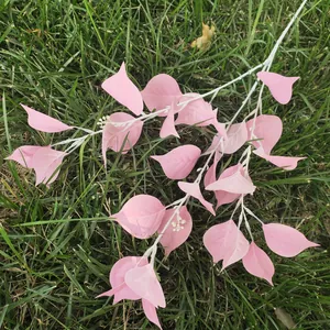 Detail view of pink artificial pipal leaf branch, perfect for home and wedding decor.