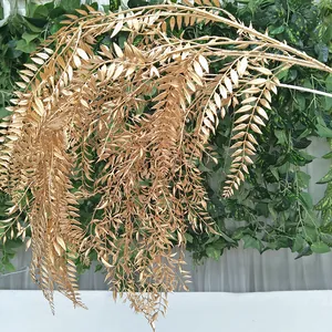 Golden artificial plant detail view, cascading artificial leaves for wedding decoration.