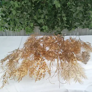 Gold artificial plant branches for wedding decoration, faux foliage and leaves arrangement.