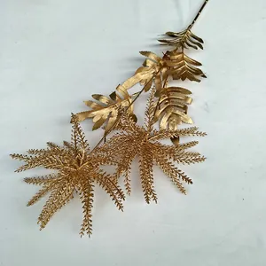 Gold artificial plant branch for wedding decor, metallic fern leaf stem for home display.