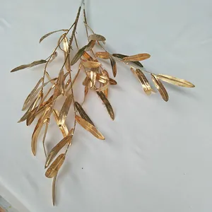 Close-up detail of golden artificial plant branch for wedding decoration and floral display.