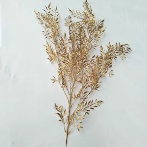 Gold artificial plant detail, decorative golden foliage branch for wedding and home display.