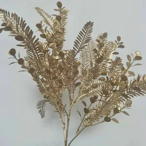 Close-up detail of golden artificial plant branch, perfect for wedding decoration display.