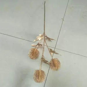Gold artificial plant branch detail, elegant faux flower stem for wedding decor and floral arrangement.