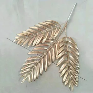 Gold artificial palm leaf branch detail view, perfect for wedding and home decor arrangement.