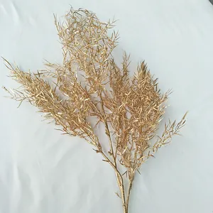 Gold artificial plant branch for wedding decor, detailed golden foliage for floral arrangements.