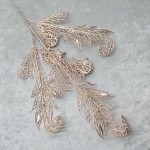 Detail of golden hollow artificial leaf branch, perfect for wedding decoration and floral display.