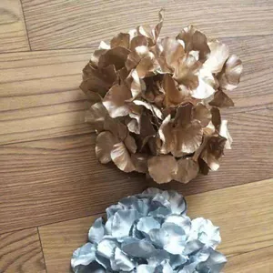 Detail view of gold and silver artificial flower heads for wedding decor and floral arrangements.