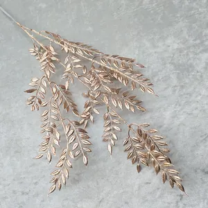 Golden artificial fern leaf branch, premium metallic floral stem for wedding decor and home display.