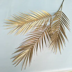Gold artificial palm leaf detail, realistic phoenix tail plant branch for wedding decor.