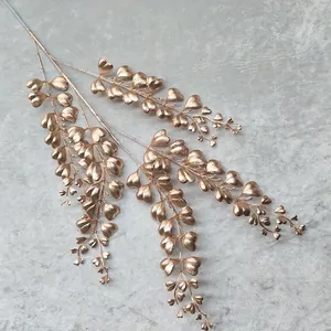 Golden artificial plant branch with heart-shaped leaves, perfect for wedding and home decor.
