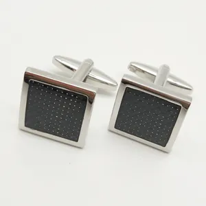 Men's square metal cufflinks detail view, premium black textured inlay for business shirts.