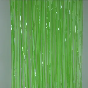 Green fringe curtain detail view, perfect for party backdrop and festive wall decoration setup.