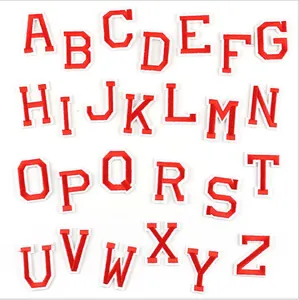 Detailed view of red and white embroidered letter patches, alphabet appliques for clothes.