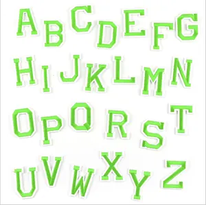 Close-up detail of green and white embroidered alphabet patches, perfect for DIY clothing decor.