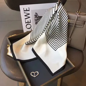 Silk square scarf for women, elegant black and white geometric pattern, 70x70cm versatile accessory.