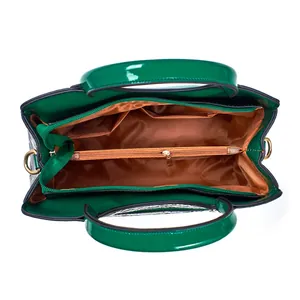 Interior detail of a green crocodile pattern handbag with multiple compartments