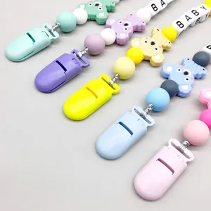 Detailed macro view of colorful silicone koala pacifier clips with BABY letter beads