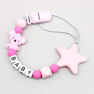 Close-up of pink silicone baby pacifier clip with koala, star and alphabet beads