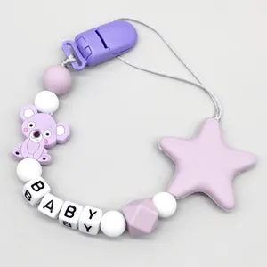 Close-up detail of silicone pacifier clip with cute koala charm and BABY letter beads
