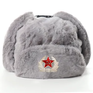 Close-up detail of the grey plush ushanka winter hat featuring a classic red star badge.