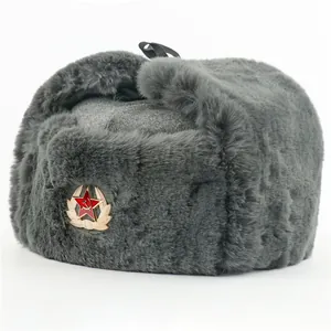 Detailed view of the winter warm grey faux fur ushanka hat with vintage Soviet badge.