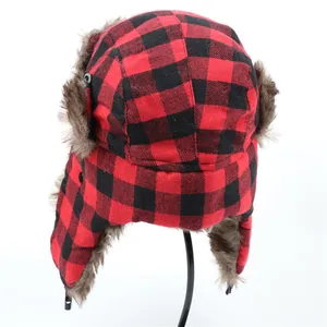 Detailed view of the red and black buffalo plaid trapper hat featuring warm faux fur ear flaps.