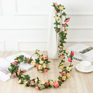 Artificial rose flower vine for home decoration, hanging garland with pink and yellow flowers.