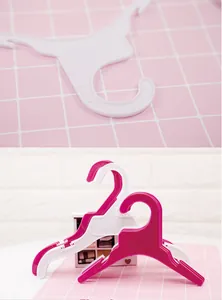 Plastic clothes hangers for small dogs, pets and children clothing display, cute pink grid.