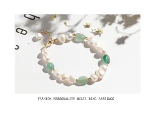 Handmade irregular freshwater pearl bracelet with green aventurine stones and gold clasp.