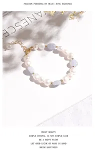 Elegant irregular freshwater pearl bracelet with blue gemstones on white background.