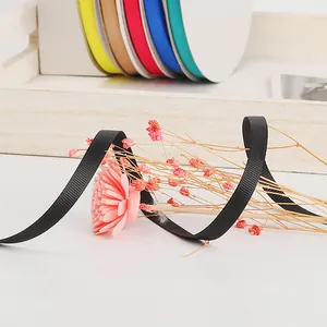 Close-up detail of black grosgrain ribbon for hair bows, gift wrapping, and DIY crafts.